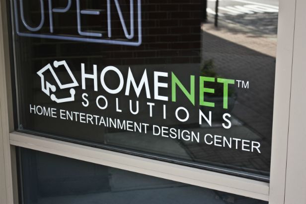 Home Net Solutions. This incorporates a logo in window lettering on a storefront.